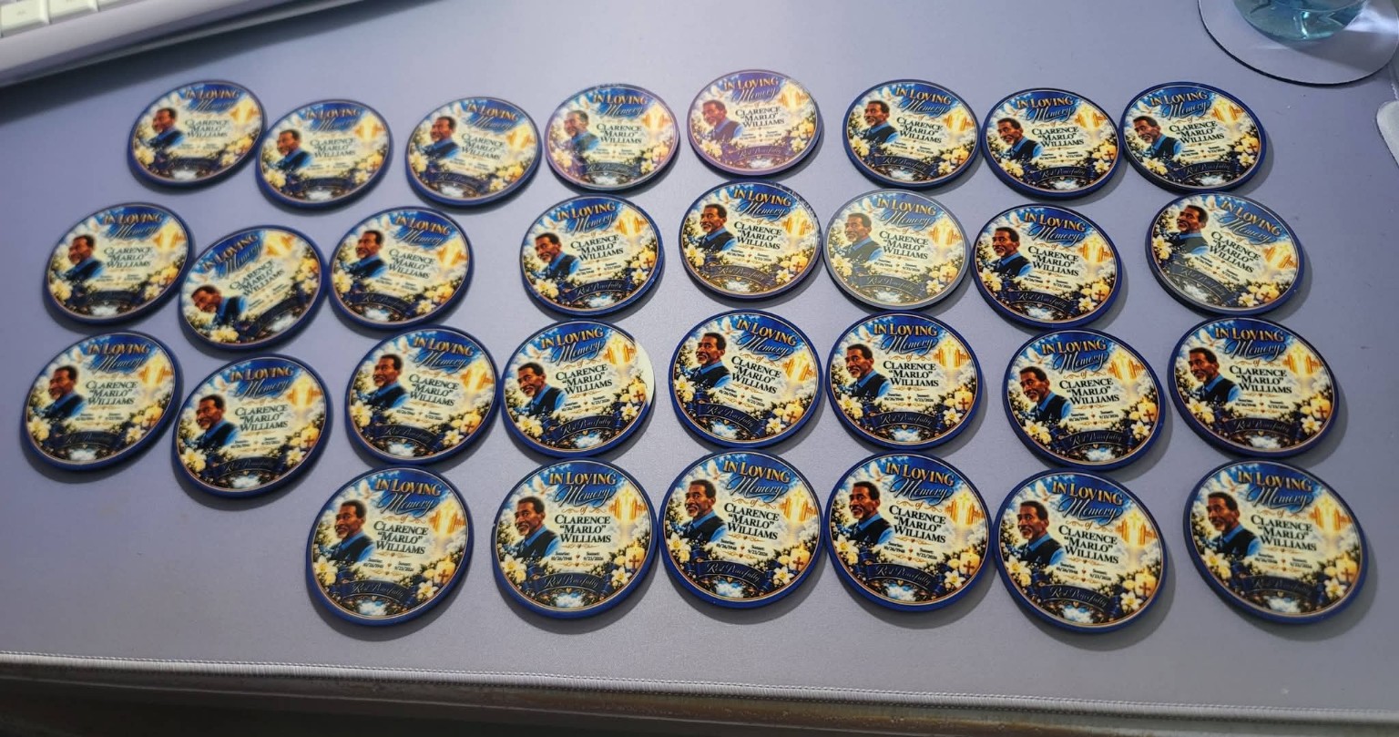 Personalized memorial portrait buttons arranged on a table